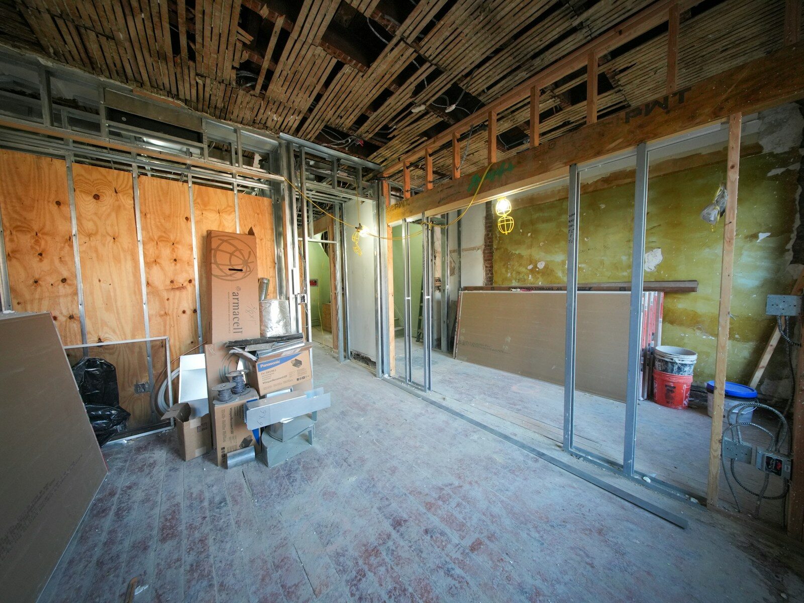Interior room under construction with exposed framing and ceiling.